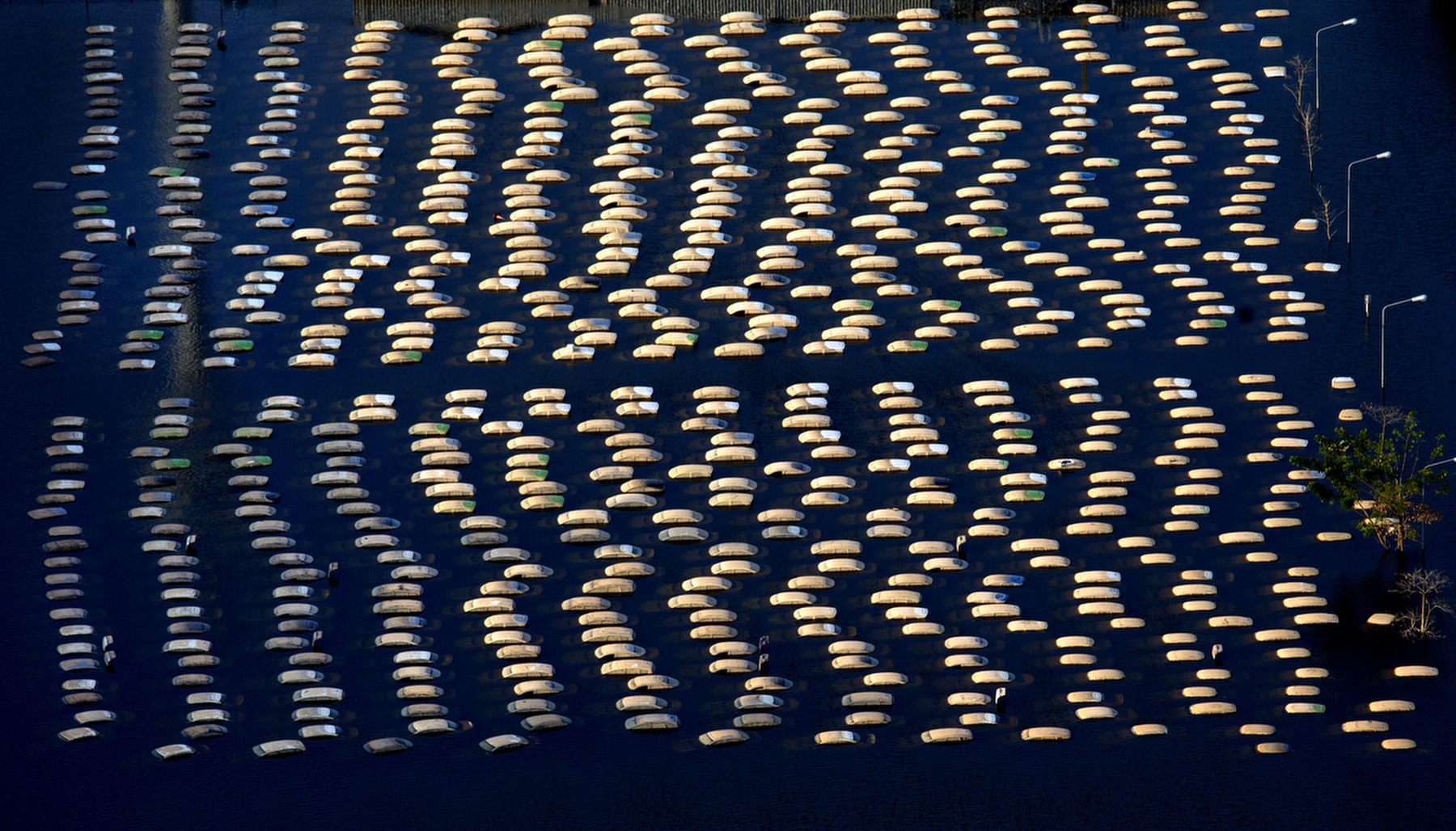 AYUTTHAYA,THAILAND - NOVEMBER 14 :  Honda vehicles are seen in an aerial photo at the flooded Honda factory in the Rojuna Industrial district November 14, 2011 in Ayutthaya, Thailand. While the city of Ayutthaya is recovering from the floods the factories are still underwater for at least a month.  Over seven major industrial parks in Bangkok and, thousands of factories have been closed in the central Thai province of Ayutthaya and Nonthaburi with millions of tons of rice damaged. Across the country, the flooding which is now in its third month has affected over 25 of Thailand\'s 64 provinces. Thailand is experiencing the worst flooding in over 50 years which has affected more than nine million people. Over 400 people have died in flood-related incidents since late July according to the Department of Disaster Prevention and Mitigation.(Photo by Paula Bronstein /Getty Images)