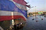 BANGKOK,THAILAND - NOVEMBER 16 :  An old tattered Thai flag blows over a bridge in the flooded district of Rangsit November 16, 2011 in Bangkok, Thailand. U.S Secretary of State Hillary Clinton Clinton came to Thailand today to offer support and significant US help in confronting Thailand\'s massive flooding. Over seven major industrial parks in Bangkok and, thousands of factories have been closed in the central Thai province of Ayutthaya and Nonthaburi with millions of tons of rice damaged. Across the country, the flooding which is now in its third month has affected 25 of Thailand\'s 64 provinces. Thailand is experiencing the worst flooding in over 50 years which has affected more than nine million people. The death toll stands at 562 people. (Photo by Paula Bronstein /Getty Images)