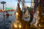 RANGSIT,THAILAND - OCTOBER 24rd: A flooded shop selling buddha statues is seen along the flooded streets in Rangsit on the outskirts of Bangkok October 24, 2011 in Bangkok, Thailand. Hundreds of factories closed in the central Thai province of Ayutthaya and Nonthaburi as the waters come closer to threaten Bangkok as well. Around 350 people have died in flood-related incidents since late July according to the Department of Disaster Prevention and Mitigation. Thailand is experiencing the worst flooding in 50 years with damages running as high as $6 billion which could increase of the floods swamp Bangkok.(Photo by Paula Bronstein /Getty Images)