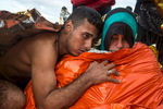 LESBOS, GREECE - OCTOBER 27: A Syrian man hugs his wife who is getting medical attention suffering from hypothermia after arriving on a raft to the island of Lesbos, Greece on October 27, 2015. Dozens of rafts and boats are still making the journey daily via the Aegean Sea, over 590,000 people have crossed into the gateway of Europe. Nearly all of those are from the war zones of Syria, Iraq and Afghanistan. (Photo by Paula Bronstein)