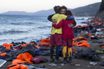 LESBOS, GREECE - OCTOBER 30: Israeli Doctor Essam Daod ( center) cries getting comforted by Proactiva lifeguards from Spainon Lesbos, Greece on October 30, 2015. The emergency team made a huge effort trying to save the refugee who later died after being rescued from the open waters of the Aegean sea. The man died despite the efforts of the lifeguards and medical personnel to revive him. Dozens of rafts and boats are still making the journey daily over 590,000 people have crossed into the gateway of Europe. Nearly all of those are from the war zones of Syria, Iraq and Afghanistan. (Photo by Paula Bronstein)