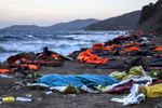 LESBOS, GREECE - OCTOBER 30: The body of a man is seen covered by a blanket after being rescued from the open waters of the Aegean sea on the island of Lesbos, Greece on October 30, 2015. The man died despite the efforts of the lifeguards and medical personnel to revive him. Dozens of rafts and boats are still making the journey daily over 590,000 people have crossed into the gateway of Europe. Nearly all of those are from the war zones of Syria, Iraq and Afghanistan. (Photo by Paula Bronstein)
