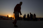 LESBOS, GREECE - NOVEMBER 4 :  A handicapped Syrian refugee man carries some food as the sunsets at Oxy transitional camp  on Lesbos, Greece on November 4 , 2015.  Dozens of rafts and boats are still making the journey daily over 590,000 people have crossed into the gateway of Europe. Nearly all of those are from the war zones of Syria, Iraq and Afghanistan. (Photo by Paula Bronstein)
