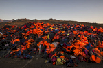 LESBOS, GREECE - NOVEMBER 12: Lifejackets are seen everywhere taking over a garbage dump in Molyvos, Lesbos. According to the IOM, an estimated 100,000 people landed in Greece, an average of almost 4,500 per day in late October and November. Nearly all of those entering Greece on a boat from Turkey are from the war zones of Syria, Iraq and Afghanistan. (Photo by Paula Bronstein)
