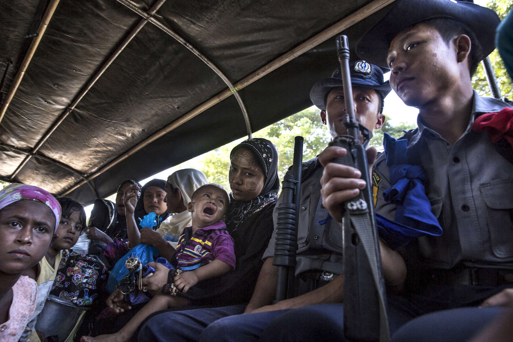 SITTWE - NOV 9: Rohingya from Aung Mingalar are escorted by Burmese police in a truck heading back to their remote community after being allowed to shop at the IDP camp market. There are no facilities in the Aung Mingalar area so many depend on this weekly trip.(Paula Bronstein for The Washington Post via Getty Images)