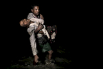 SHAH PORIR DWIP, BANGLADESH - SEPTEMBER 27: Sona Banu gets carried by Nobi Hossain through the shores of the Naf river as hundreds of Rohingya arrive by boats in the safety of darkness September 27, on Shah Porir Dwip island, Cox's Bazar, Bangladesh. Over 655,000 Rohingya refugees have fled into Bangladesh since late August during the outbreak of violence in Rakhine state.The refugee emergency unfolded in late August after an attack on state security forces by Rohingya insurgents, triggering a brutal military crackdown that has forced more than half of the country’s 1.1 million population fleeing to neighboring Bangladesh creating the fastest cross-border exodus ever witnessed with over 630,000 new arrivals. Thousands of children who are traveling alone are at serious risk of trafficking and exploitation. Many traumatized refugees arrived telling stories of horror alleging rape, killings and the burning of hundreds of villages, which have been well documented by the media, along with the U.N and various human rights groups. 