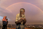  Abu Siddique, 90, stands on a hill overlooking the Kutupalong refugee camp as a rainbow covers the sky. He had to pay people to carry him across the Myanmar border to Bangladesh spending all of his savings. 
