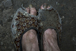 Opytne: Donetsk region: Raisa Petrovna, 80 can't afford new shoes so she wears the same old slippers every day. Raisa Petrovna, 80 and her husband Stanislav Vasilyevich live in a village often caught in the crossfire between Ukrainian and Pro-Russian separatists, too close to the contact line.