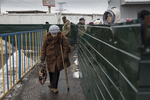 Mayorsk, Ukraine: An elderly handicapped woman slowly makes her way along the border crossing to Donetsk after making the exhausting journey to get her pension in Eastern Ukraine. 