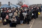 Thousands of Ukranian refugees wait in long lines for many hours near the Polish border at Budomierz to cross into Poland from Ukraine. Two million refugees have fled Ukraine, most into Poland.(Photo by Paula Bronstein / Politico )