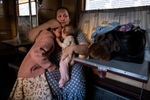 Elena Pomaz from Kherson, under Russian occupation cries as she holds her children, Liza, age 6, and Sofia ,4 months  on July 1, 2022. The family got emotional after relatives came on board to visit them, saying goodbye was difficult. The train arrives daily to Dnipro from Ukraine’s war ravaged eastern region carrying refugees for a brief stopover en route towards Lviv.