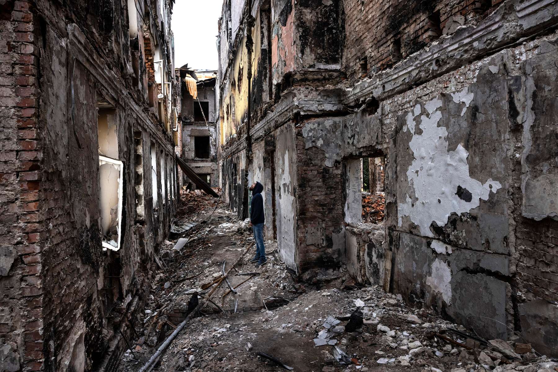 A man stands inside the ruins of a school in Kharkiv, One of the most common targets for Russian artillery, missiles, and airstrikes have been schools, over a 115 have been hit.