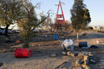 Within days of the camp's official closure on February 20, 2018, county clean-up crews moved through the encampment, tearing down structures that remained and cleaning up trash. On this particular night, Anaheim Stadium's adjacent parking lot was packed for a Monster Truck rally.