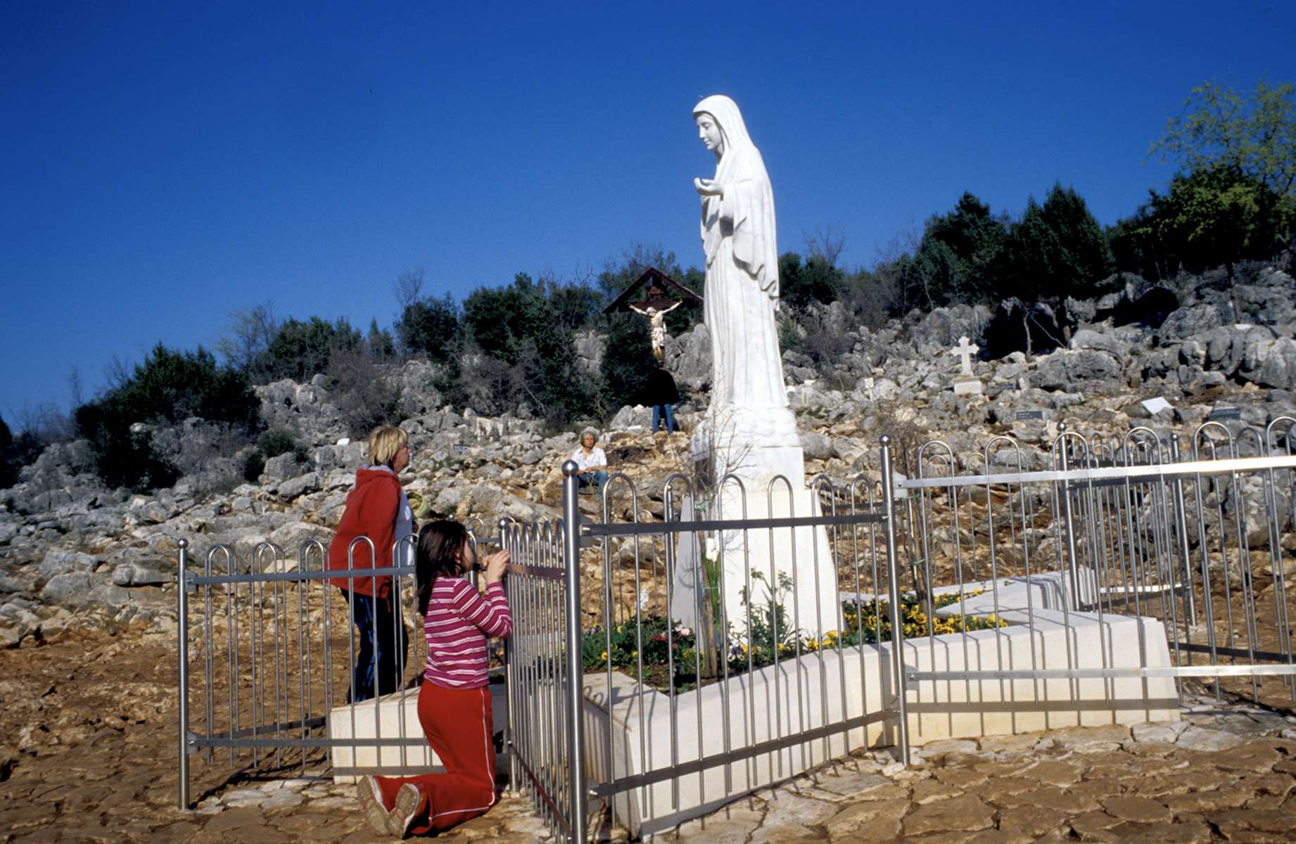 Statue of the Virgin Mary marks the spot where six teenagers from Medzugorge claim that the mother of Jesus came to them in a vision in 1981 and gave them a message of peace. Thousands of religious pilgrims from around the world visit the site each year. Several of the teenagers, now grown, say they still have regular visions of Mary, who continues to give them messages to share with the world.