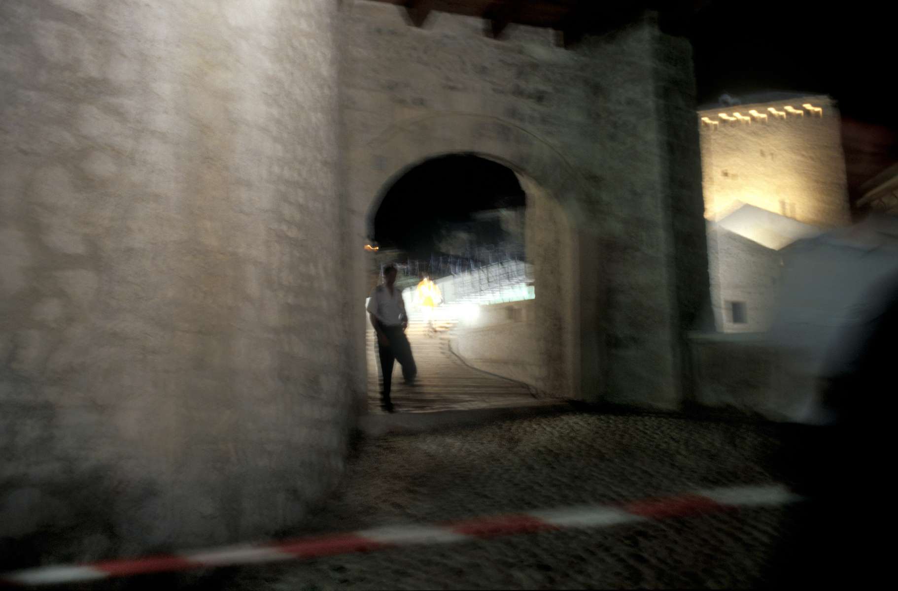 A policeman guards the entrance to the newly rebuilt Mostar Bridge the night before dedication ceremonies and the re-opening of the bridge, which was destroyed by Croat forces during the war.