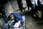 Police crime scene technicians examine the remains of a Muslim man killed in May 1992 and exhumed eight years later. Every exhumation is attended by crime scene experts who send their reports to the war crimes tribunal at The Hague for use in possible prosecution there. October 2000.