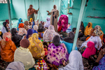 Women at Kinshasa's central mosque listen while Maman Ansar facilitators discuss family planning methods after Friday prayers. September 2016.