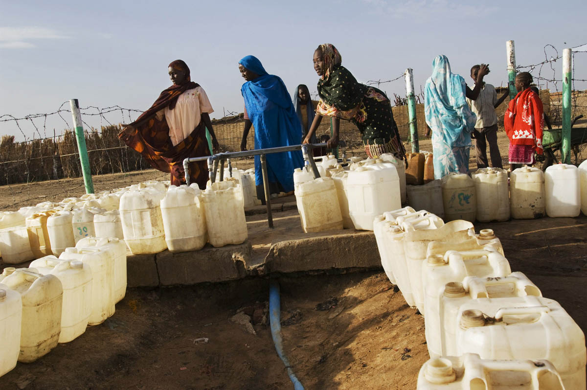 Women line up jerry cans for water at one of the few functional water points in the sprawling Kalma IDP camp.  As the Darfur conflict intensified, Kalma grew into one of the largest camps in the region.Kalma, Southern Darfur State