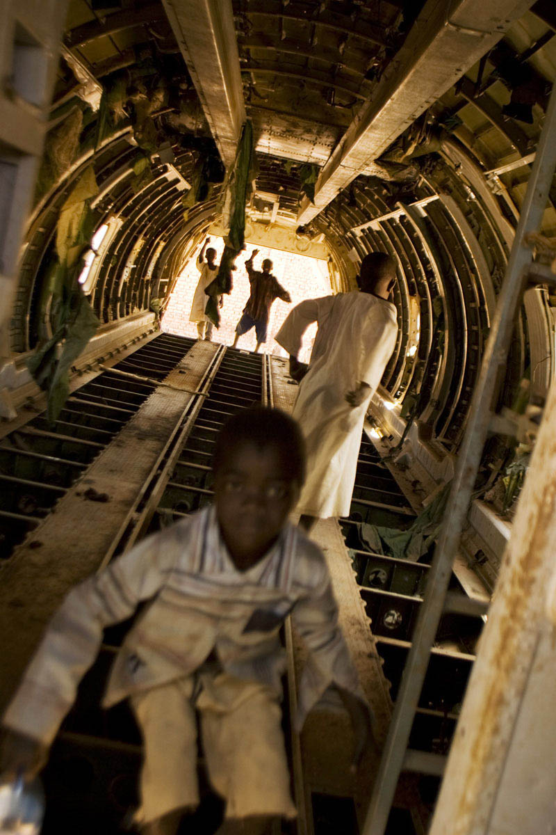 Children play in the fuselage of a crashed Sudan Armed Forces Antonov bomber.  A local resident remarked on the plane, “During the war this plane came and killed many people - then it died here.”Raja, Western Bahr el Ghazal State