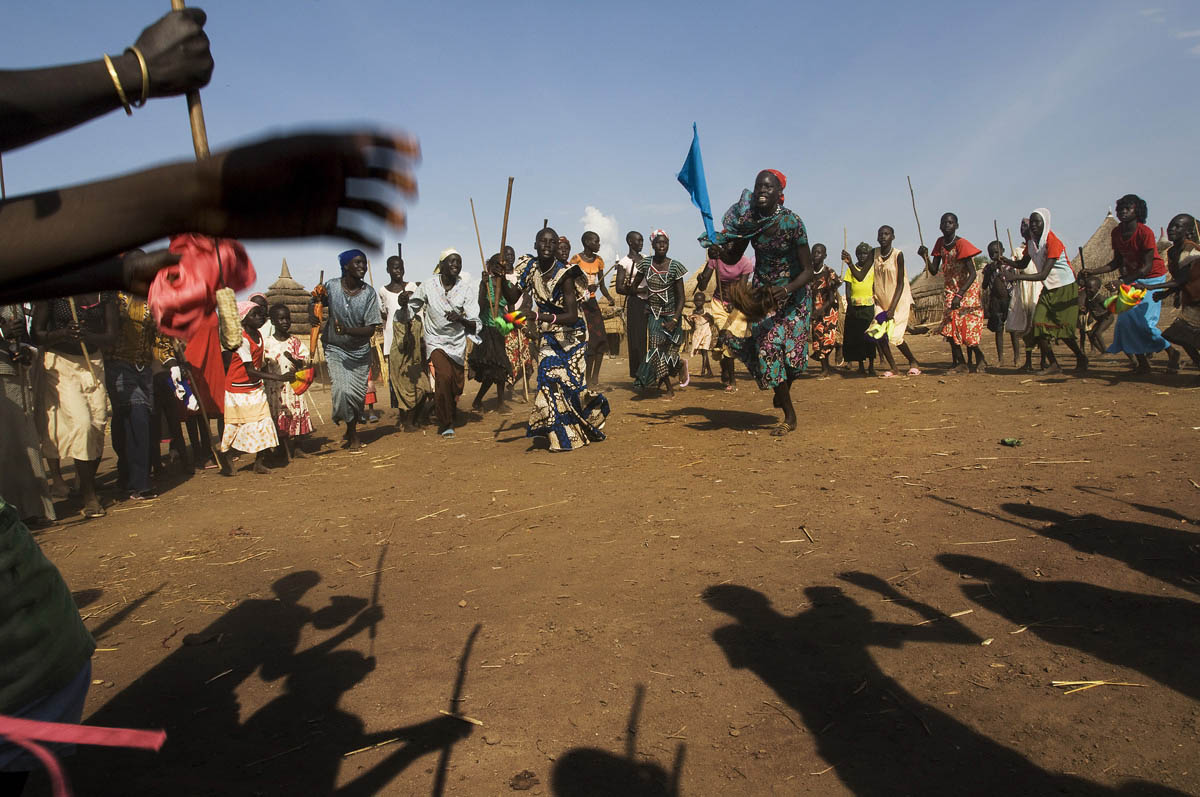 Young Jikany Nuer girls dance following the agreement of the bride price for one of their age mates.  In many pastoral societies marriage negotiation is a complicated process involving extended families reaching agreement on the number of cattle to be paid as dowry.Jikmer, Upper Nile State