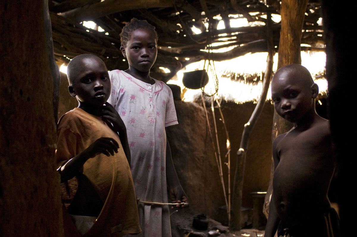 Young children stand in the kitchen of their homestead on the rocky hills of the Nuba Mountains.Kauda, Southern Kordofan State