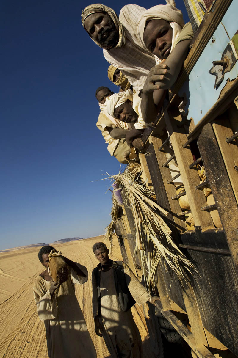 Migrant workers cross the Nubian Desert by truck in search of gold.  Recent discoveries of gold in the area around Atbara have brought prospectors from across Sudan seeking their fortune or at least a meager income.Nubian Desert, Nile State
