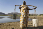 A woman collects water from a lake.  Bau is located in central Blue Nile State and formed a part of the long frontline during the north-south civil war and witnessed intense fighting.Bau, Blue Nile State