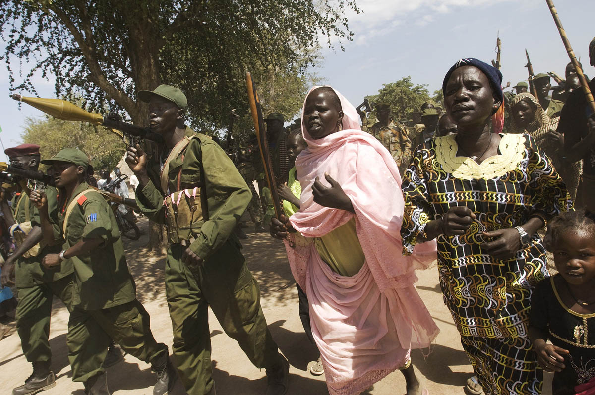 SPLA soldiers and their families parade during a visit by the Governor and Division Commander to their barracks near the border with Sudan.Timsaha, Western Bahr el Ghazal, South Sudan