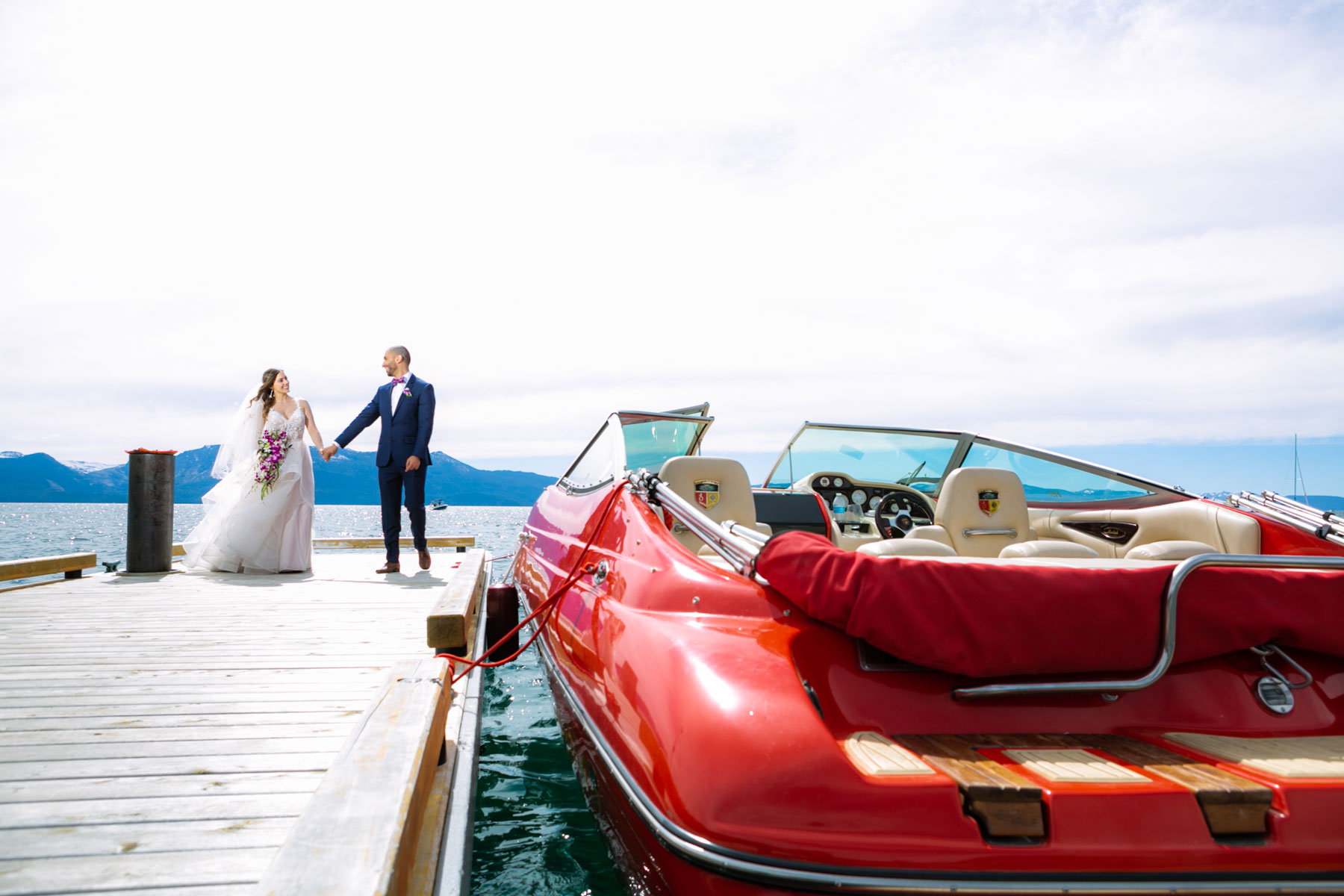 Lovely wedding at Round Hill pines Lake tahoe. Bride and groom and a awesome reb Boat
