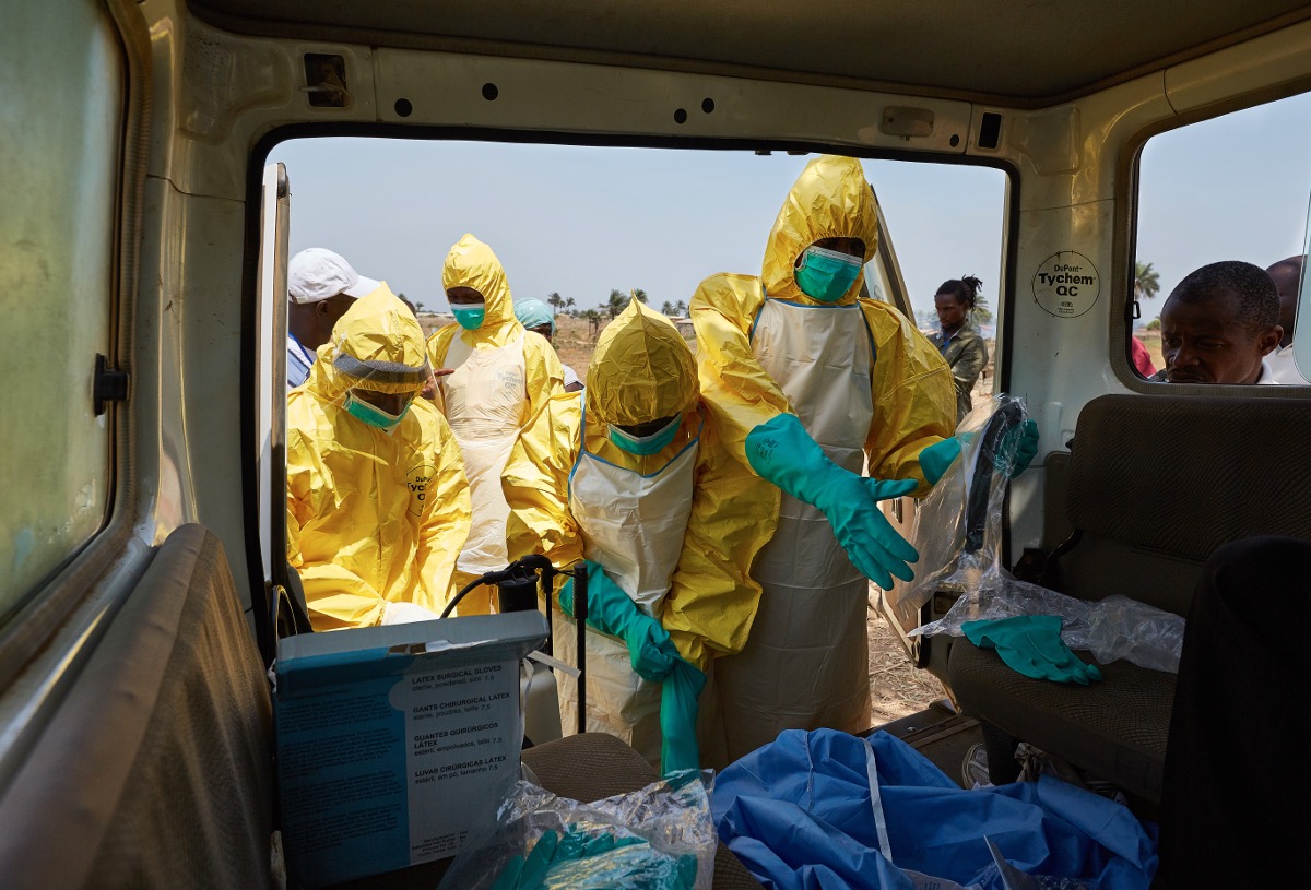 Dangerous work. A team prepares to carry out a safe & dignified burial of an Ebola victim.  Waterloo, Sierra Leone