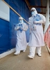 UK NHS staff wearing full PPE entering the red zone at Kerrytown Ebola treatment centre. Sierra Leone