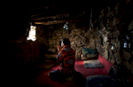 October 25, 2007- Khenj, Afghanistan: Burhan Amin, 26, prays in the one room stone he shares with the rest of his team of miners in the slope of the Hindu Kush mountains towering over the Panjshir Valley near the village of Khenj, in Afghanistan on Thursday October 25, 2007. Burhan Amin, 26, a partner and cousin of Mr. Jawead, has a kidney ailment that does not allow him to work, brought on from years of battling the mountain for emeralds. Instead of maning the rock drill, Mr. Amin prepares the meals of rice, bread, lamb meat and tea for grime covered miners.  Even with this light duty, he sometimes feels too ill to work.  “Most of the time I am sick. Those days when I am not feeling well, because there is the mountain and it is the work of the mountain. If we work from the morning till night, you will know how much you get tired,” Mr. Amin said. 