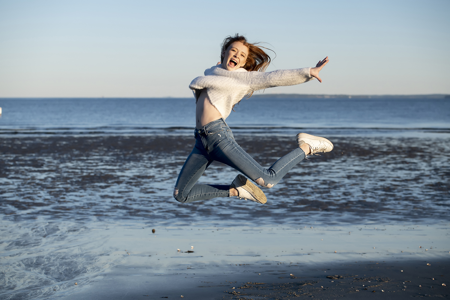 girl leaping at beach in Greenwich, CT