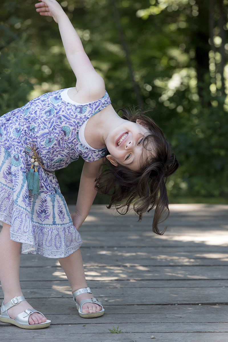 girl being silly during family portrait session in New Jersey park