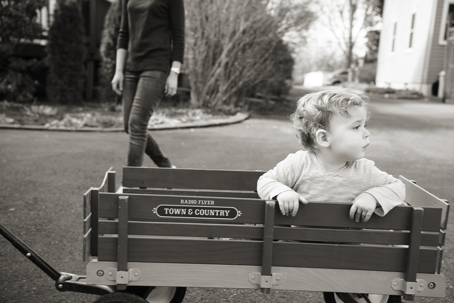 boy rides in his wagon during family portrait session