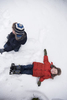 Twin brothers play in the snow during their family session on Long Island