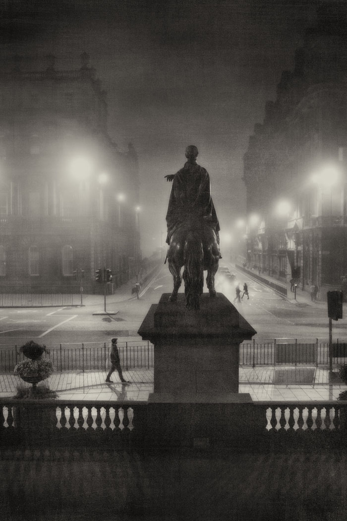 Duke of Wellington statue at the bottom of North Bridge Edinburgh on a foggy night.