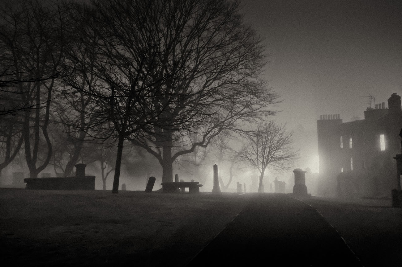 Greyfriars kirk graveyard at night in the fog.