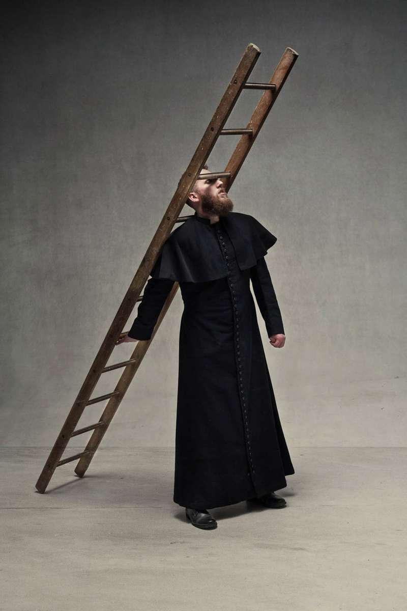priest with a ladder resting on him covering his eyes