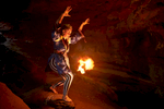 pagan woman in a dark cave with a ball of fire.