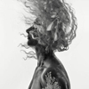 double exposure nude of a woman with flying hair