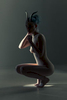 crouching naked woman in a dark lit studio wearing animal horns on her head. 