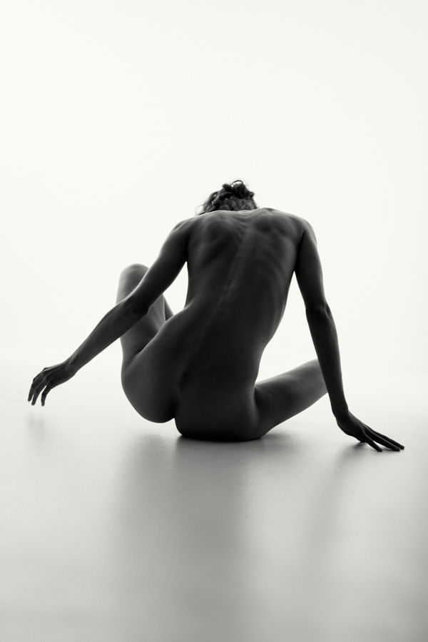 seated naked girl in a studio