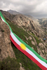 The Kurdish flag draped over the mountains of Akre.  On September 25th, 2017 the Kurdistan region of Iraq held a symbolic referendum.  They asked if they wanted to be a free people and their own nation.  It was a resounding yes.  This was immediately met with violence from Baghdad, Iran and Turkey.  There was no outside support for an independent nation for the Kurds.  This included the United States, whom after years of using the Peshmerga to fight ISIS, now {quote}remained neutral{quote} but whose weapons were used by the Iraqi military to kill Peshmerga soldiers along with Kurdish civilians.