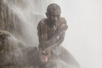 A pilgrim braces himself beneath the pounding waters of Saut-d'Eau.  The Vodou ancestor spirit, Danbhalah, is believed to have plunged into these abyssal waters in order to induce the abysses to give birth to the world.