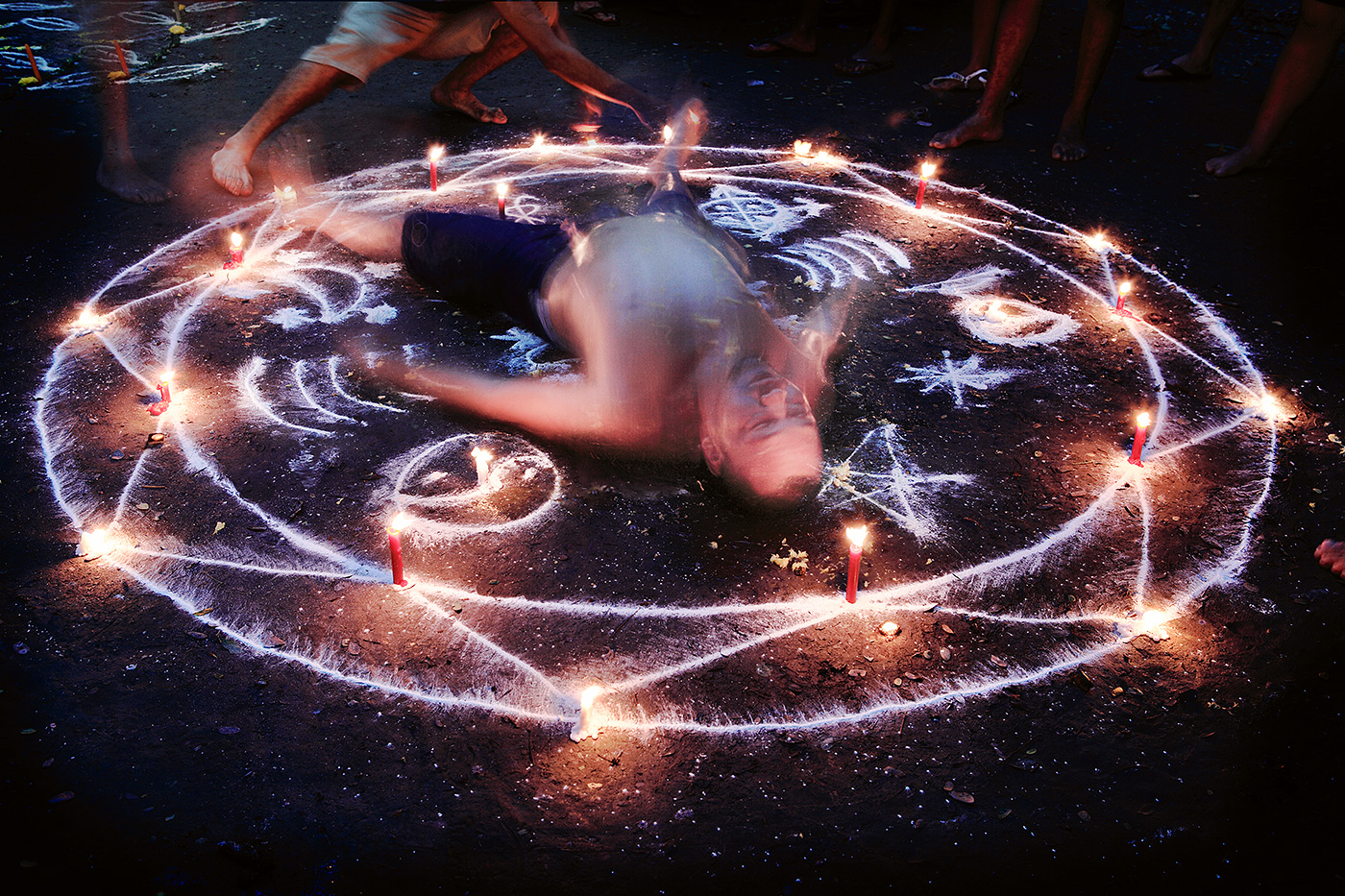 Writhing in convulsions, the power of the oracle brings this man into a trance as the spirit enters his body.