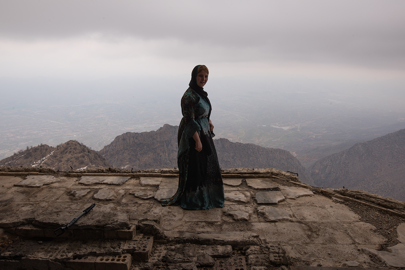 A kurdish woman stands atop the bombed out ruins of Saddam Hussein's summer palace on Gara mountain.  From this vantage point Hussein would plan the al-Anfal genocide which resulted in the slaughter of tens of thousands of Kurds from 1986 to 1989.