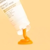 A creative swatch of InstaNatural's vitamin C peel off mask photographed against yellow.