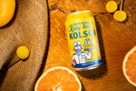 Genesee's Ruby Red Kolsch photographed on a board with sliced grapefruit.