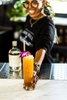 A bartender for Barr Hill Gin serves one of their signature summer cocktails.